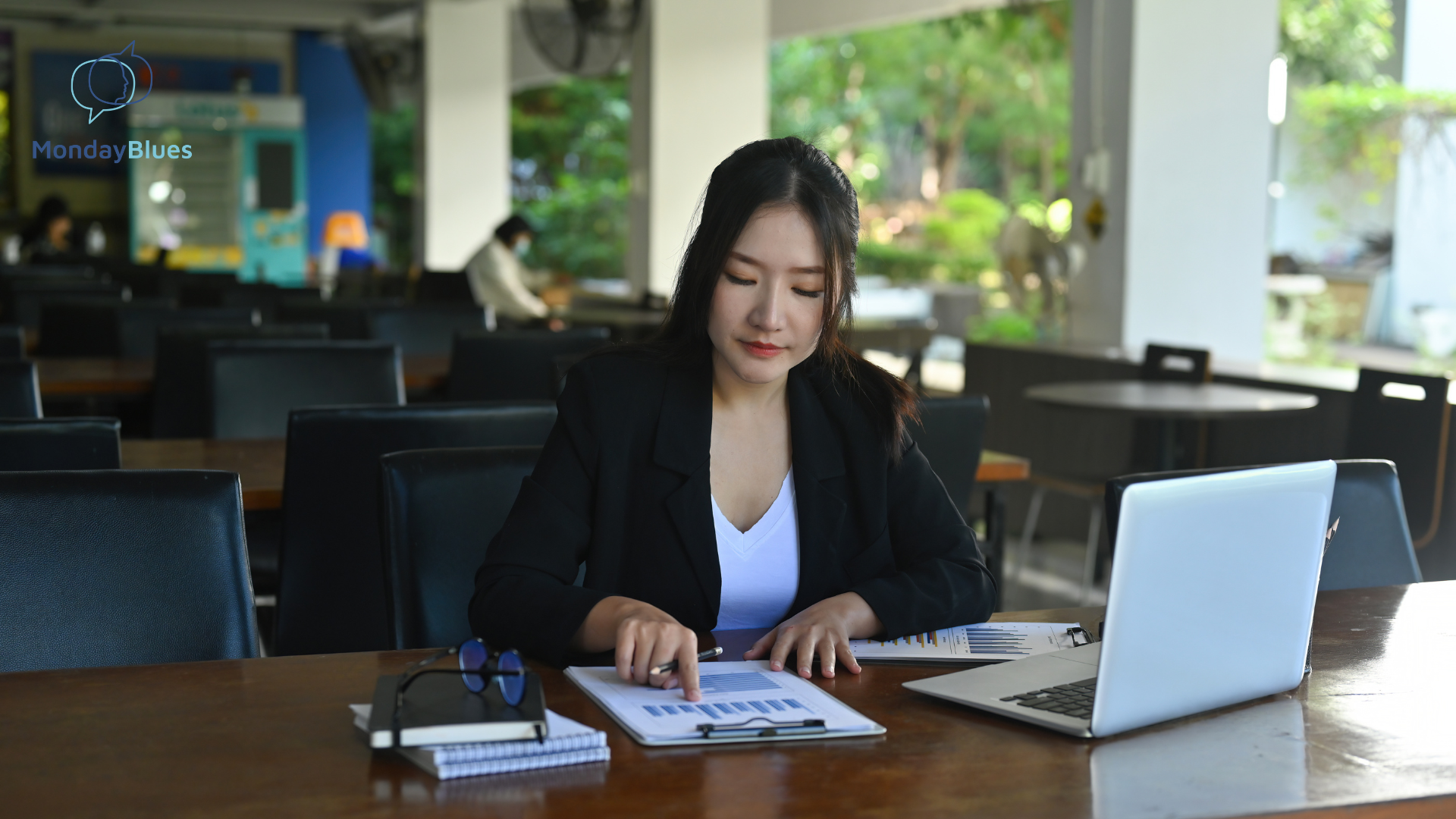 A woman in an office happily engaged in paperwork, symbolizing positive engagement and productive work in a healthy company culture.